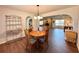 Cozy dining area with a round table, wood floors, and an open view to a living area with fireplace at 1711 Sw 63Rd St Rd, Ocala, FL 34476