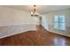 Wood-floored dining room with classic chandelier and decorative wainscoting at 1711 Sw 63Rd St Rd, Ocala, FL 34476