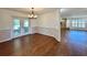 Bright dining room with wood floors and classic chandelier, leading to a cozy living space at 1711 Sw 63Rd St Rd, Ocala, FL 34476
