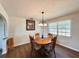 Bright dining room featuring a round wood table, chandelier, and natural light from a large window at 1711 Sw 63Rd St Rd, Ocala, FL 34476