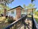 Back view of a house with a ramp, leading to a covered patio at 1711 Sw 63Rd St Rd, Ocala, FL 34476
