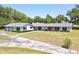 Sprawling ranch home with brick and white accents surrounded by lush greenery at 1711 Sw 63Rd St Rd, Ocala, FL 34476