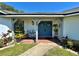 Inviting entryway with a blue double door and decorative plants at 1711 Sw 63Rd St Rd, Ocala, FL 34476