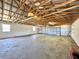 Spacious garage featuring a metal ceiling, concrete floor, and door at 1711 Sw 63Rd St Rd, Ocala, FL 34476