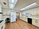 Spacious kitchen with wood floors, white appliances, and ample counter space at 1711 Sw 63Rd St Rd, Ocala, FL 34476