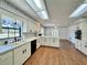 Well-lit kitchen with white cabinets, a double sink, and updated appliances at 1711 Sw 63Rd St Rd, Ocala, FL 34476
