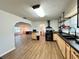 Spacious kitchen with a large sink, wood cabinets, open shelving, and an open layout to other living areas at 1711 Sw 63Rd St Rd, Ocala, FL 34476