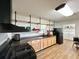 Functional kitchen with wood cabinets, black appliances, open shelving, and a sleek black range hood at 1711 Sw 63Rd St Rd, Ocala, FL 34476