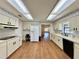 Bright, open kitchen with white appliances and a connected desk area at 1711 Sw 63Rd St Rd, Ocala, FL 34476