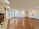 Open-concept living room boasting a large brick fireplace and hardwood floors at 1711 Sw 63Rd St Rd, Ocala, FL 34476