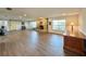 Open living room featuring barn door, wood-look floors, stone fireplace, and lots of space at 1711 Sw 63Rd St Rd, Ocala, FL 34476