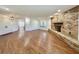 Bright living room featuring hardwood floors, double doors, and brick fireplace at 1711 Sw 63Rd St Rd, Ocala, FL 34476