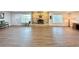Open concept floor plan with wood-look flooring and bright natural light at 1711 Sw 63Rd St Rd, Ocala, FL 34476