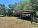 Outdoor wooden structure with metal roof and lush surrounding landscape at 1711 Sw 63Rd St Rd, Ocala, FL 34476