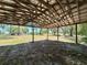 Open-sided wooden structure overlooking a grassy field and trees at 1711 Sw 63Rd St Rd, Ocala, FL 34476