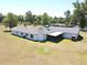 Back of home showing a screened in porch, chimney, and fenced acreage at 1711 Sw 63Rd St Rd, Ocala, FL 34476