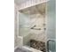 A walk-in shower featuring a pebble floor and glass doors with marble wall accent at 1711 Sw 63Rd St Rd, Ocala, FL 34476