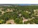 Picturesque aerial view overlooking a lush, tree-filled landscape with homes and a distant lake at 18695 Ne 5Th Terrace Rd, Citra, FL 32113