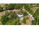 Secluded home featuring a sparkling pool, mature trees, and verdant landscaping at 18695 Ne 5Th Terrace Rd, Citra, FL 32113