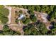 Expansive aerial view of a home with a pool, solar panels, and a large surrounding of trees at 18695 Ne 5Th Terrace Rd, Citra, FL 32113