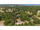 Scenic aerial view capturing a house surrounded by lush trees and overlooking a distant lake at 18695 Ne 5Th Terrace Rd, Citra, FL 32113
