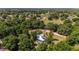 Expansive aerial view overlooking lush trees and a landscape dotted with homes and a distant lake at 18695 Ne 5Th Terrace Rd, Citra, FL 32113