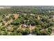 Picturesque aerial view of a home nestled among lush trees, with surrounding countryside at 18695 Ne 5Th Terrace Rd, Citra, FL 32113