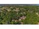 Breathtaking aerial view overlooking a home and a lush, tree-filled landscape with homes and distant lake at 18695 Ne 5Th Terrace Rd, Citra, FL 32113