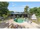 Backyard view featuring a pool, outdoor fireplace and unique landscape design, perfect for entertaining guests outdoors at 18695 Ne 5Th Terrace Rd, Citra, FL 32113