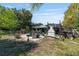 Expansive backyard featuring a pool, pergola, outdoor fireplace, surrounded by lush greenery and a fence at 18695 Ne 5Th Terrace Rd, Citra, FL 32113