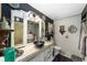 A bathroom has a vessel sink, and is decorated with vintage accessories at 18695 Ne 5Th Terrace Rd, Citra, FL 32113