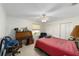 Bedroom featuring a vintage desk, ceiling fan, and double closets at 18695 Ne 5Th Terrace Rd, Citra, FL 32113