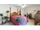 Bedroom featuring a vintage four-poster bed, side table, and assorted furniture at 18695 Ne 5Th Terrace Rd, Citra, FL 32113