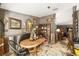 Dining area featuring a distressed wood table, chairs, and decorative wall art at 18695 Ne 5Th Terrace Rd, Citra, FL 32113