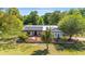 Charming house featuring solar panels and a stone garden at 18695 Ne 5Th Terrace Rd, Citra, FL 32113