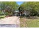 Unique garage with vibrant blue and yellow doors, offering ample space and character in a serene setting at 18695 Ne 5Th Terrace Rd, Citra, FL 32113