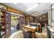Spacious kitchen with grey lower cabinets, a dining table in the center, and an open door leading to a porch at 18695 Ne 5Th Terrace Rd, Citra, FL 32113
