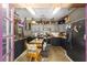 An interestingly decorated kitchen features two-toned cabinetry, stainless steel appliances, and an unusual dining table set at 18695 Ne 5Th Terrace Rd, Citra, FL 32113