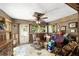 An eclectic living room is filled with boxes, furniture, and decor, with natural light streaming through the windows at 18695 Ne 5Th Terrace Rd, Citra, FL 32113