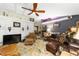 Cozy living room with comfortable seating, ceiling fan, and unique decor at 18695 Ne 5Th Terrace Rd, Citra, FL 32113