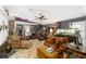 Spacious living room with vaulted ceiling, ceiling fan, and lots of seating at 18695 Ne 5Th Terrace Rd, Citra, FL 32113