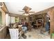 Spacious living room featuring an ornate ceiling fan, mixed decor, and natural light from the windows at 18695 Ne 5Th Terrace Rd, Citra, FL 32113