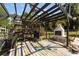 Outdoor space with colorful pergola and a charming fireplace, ideal for relaxing and grilling in the backyard at 18695 Ne 5Th Terrace Rd, Citra, FL 32113