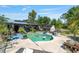 Relaxing pool area with a pergola, lush greenery and an outdoor fireplace, creating a private oasis for entertaining at 18695 Ne 5Th Terrace Rd, Citra, FL 32113