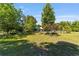 Lawn area surrounded by trees, grass and shrubbery at 18695 Ne 5Th Terrace Rd, Citra, FL 32113