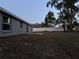 Spacious fenced backyard featuring minimal landscaping, a concrete patio, and room for outdoor activities at 203 Locust Pass, Ocala, FL 34472