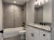 Bathroom featuring a granite countertop vanity, tiled wall accents, and a tub-shower combination at 203 Locust Pass, Ocala, FL 34472