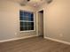 Bedroom features hardwood flooring, and a window provides natural light, creating a serene atmosphere at 203 Locust Pass, Ocala, FL 34472