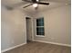 Cozy bedroom with neutral walls, wood-look flooring, a ceiling fan, and a window for natural light at 203 Locust Pass, Ocala, FL 34472