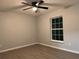Simple bedroom featuring wood-look floors, a fan, and a window providing natural light at 203 Locust Pass, Ocala, FL 34472